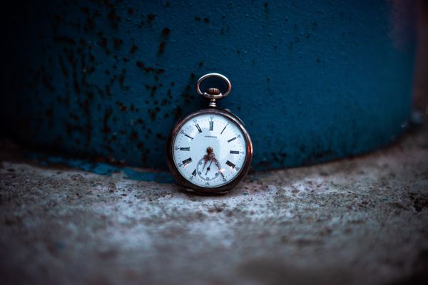 Pocket watch against a deep blue background